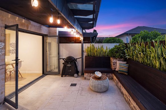 The two-storey townhouse has a covered outdoor area running off the open plan living area.