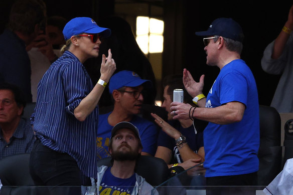 Charlize Theron chats with Matt Damon in the stands.