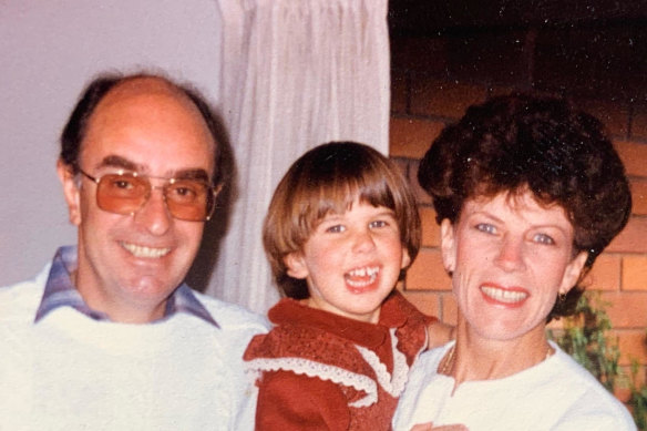 A photo of Sarah Holland-Batt as a child, with her mother and father, which was used in the funeral service video. 