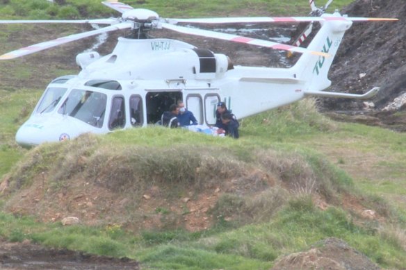 An injured person is loaded in to a helicopter to be transported to hospital.