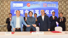 Yuxiao’s Wu Tao, left, signing a cooperation agreement with the leaders of China Northern and Shenghe Resources.