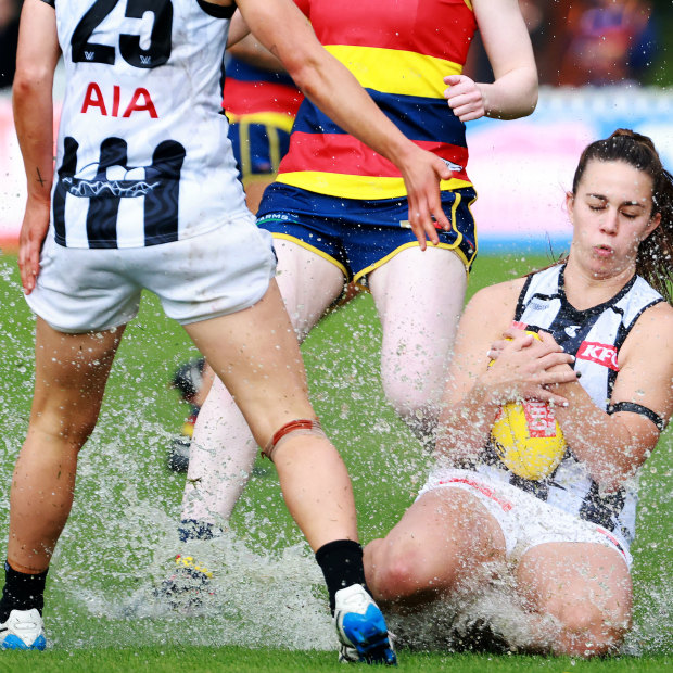 Football or swimming? Collingwood’s Chloe Molloy takes a sliding mark against Adelaide.