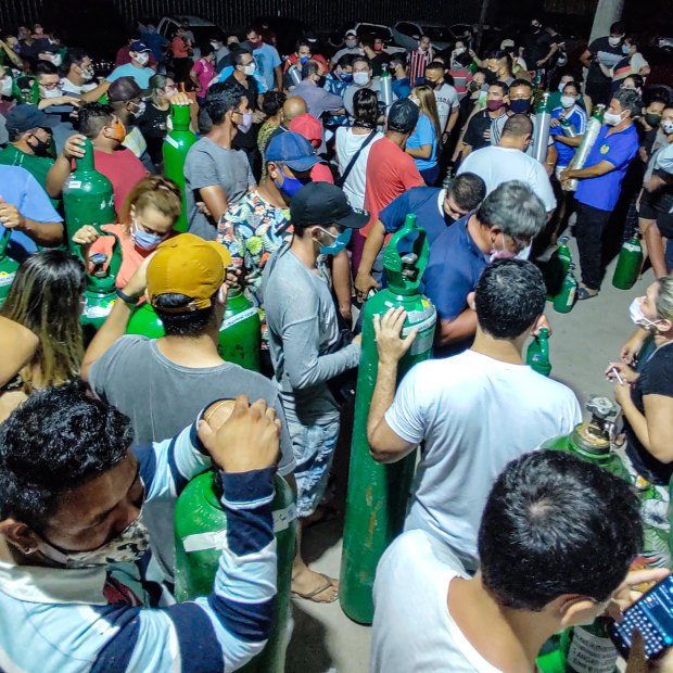 People with oxygen bottles outside an oxygen supplier in Manaus, Brazil during a second wave of COVID that may have been caused by a variant. 