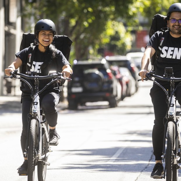 Delivery riders Mariella Bagang and Chintan Mewada work for Send in Melbourne. Unlike gig economy riders, they enjoy traditional employment.