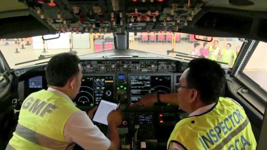 Officials inspect the cockpit of a Boeing 737 Max 8 aircraft in a hangar at Garuda Maintenance Facility at Soekarno Hatta International Airport in Jakarta on March 12.