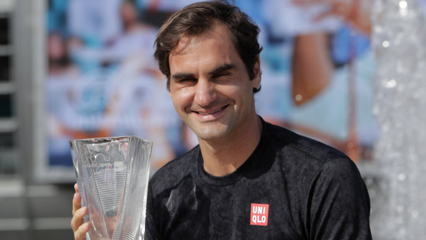 Winning never gets old: 37-year-old Roger Federer with his trophy in Miami on Sunday. 