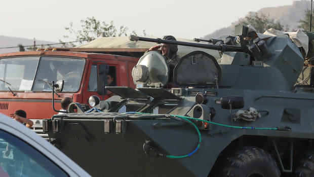 Azerbaijani military personnel drive through Baku, Azerbaijan, on Sunday.