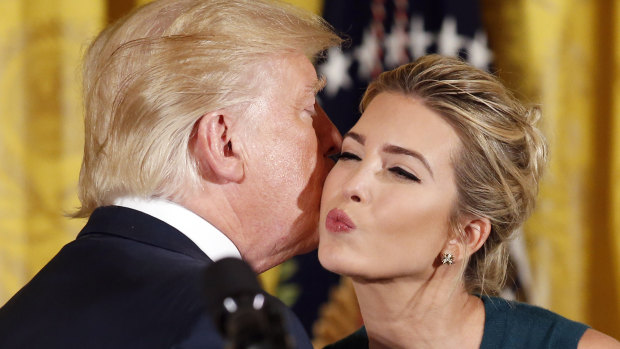 President Donald Trump kisses his daughter Ivanka in the East Room of the White House.