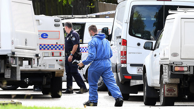 Scientific and forensic police officers scoured the Petrie street on Friday as detectives searched for the gunman.