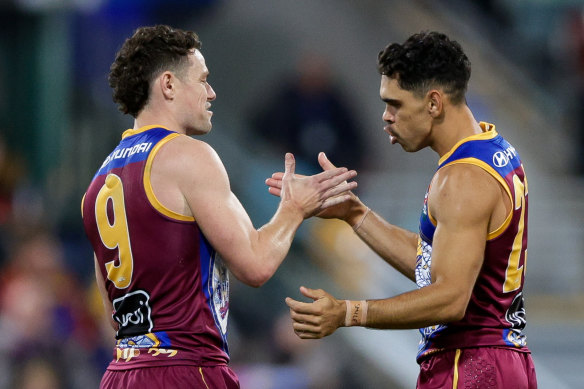 Charlie Cameron and Lachie Neale of the Lions celebrate a goal.