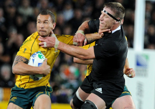Quade Cooper fends off Brad Thorn at the 2011 Rugby World Cup. 