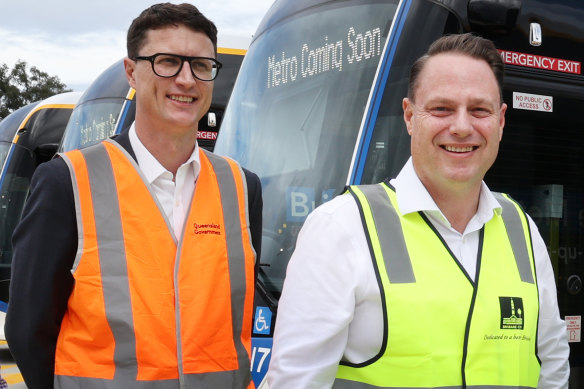 Transport Minister Bart Mellish (left) and Lord Mayor Adrian Schrinner with a Metro bus in July.