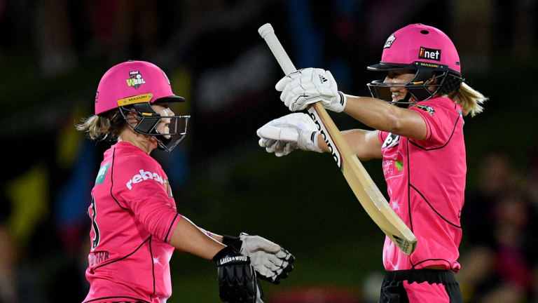 Good night: Ellyse Perry, right, and Dane Van Niekerk embrace after Perry hit a boundary to win and bring up her century.
