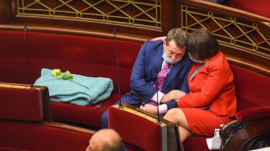 Mark Gepp is comforted during an emotional tribute to Garrett.