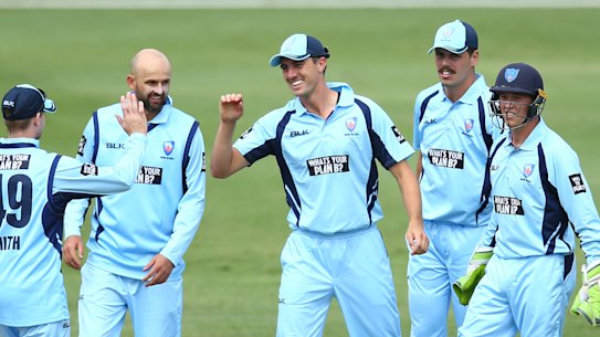 Pat Cummins celebrates with Blues teammates earlier this year in a match against Victoria. 