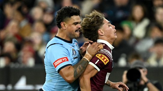Latrell Mitchell pushes Reece Walsh over during game 2 of Origin at the MCG.