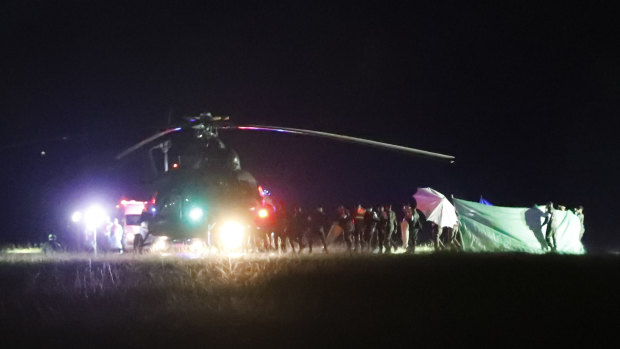 An emergency team believed to be carrying one of the rescued boys from the flooded cave heads to the hospital in Chiang Rai.