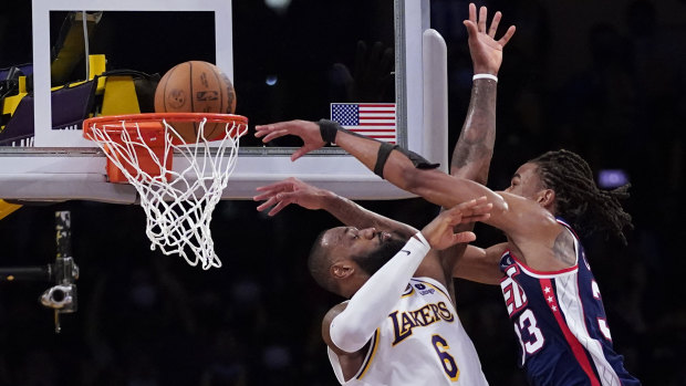 Nets big man Nic Claxton dunks over NBA legend LeBron James.