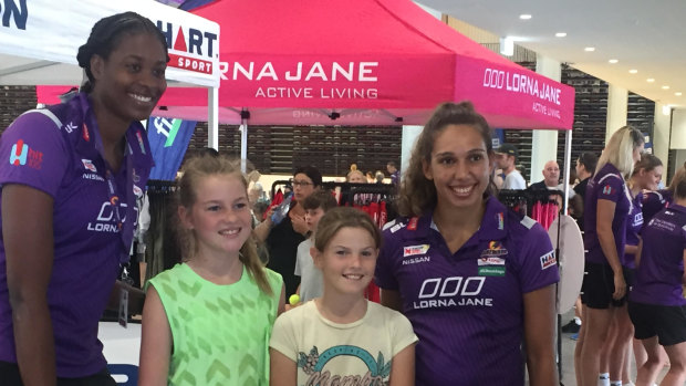 Queensland Firebird stars Romelda Aiken and Jemma Mi Mi, with young fans Ella Norton (left) and Evie Stower at the new State Netball Centre at Mount Gravatt.