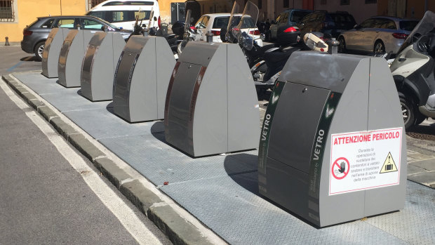 Italy's six bins system in use near the Tower of Pisa. They sit atop subterranean skip bins allowing for a greater volume of waste.