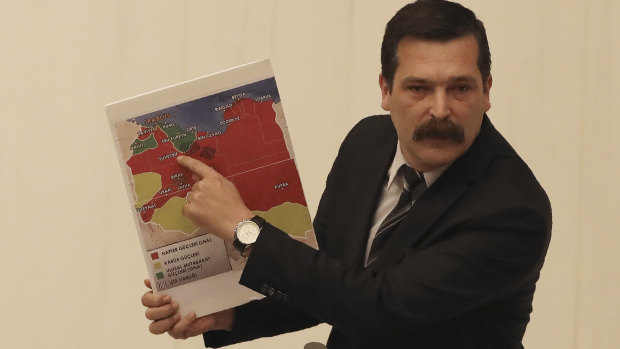 Erkan Bas, an opposition MP of the Workers' Party, shows a map of divided Libya before Turkey's parliament authorised the deployment of troops to Libya.