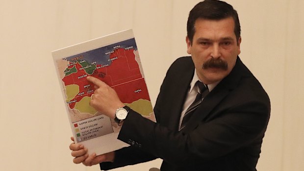 Erkan Bas, an opposition MP of the Workers' Party, shows a map of divided Libya before Turkey's parliament authorised the deployment of troops to Libya.