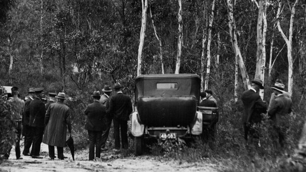 Manhunt ... Police set out to search bushland at Milperra following the discovery of the bodies.