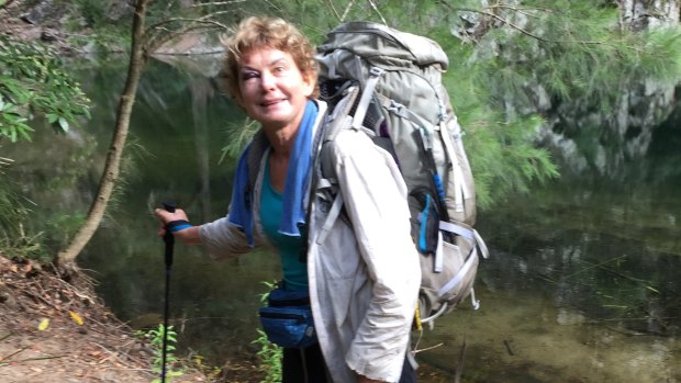 Francisca Boterhoven De Haan, with a black eye after slipping on a rock, in front of a creek during her hike in Morton National Park.