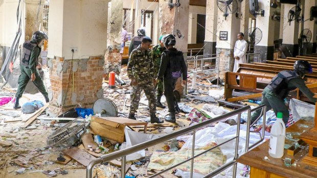 Security forces inspect the carnage after an explosion hit St Anthony's church in Kochchikade in Colombo, Sri Lanka.