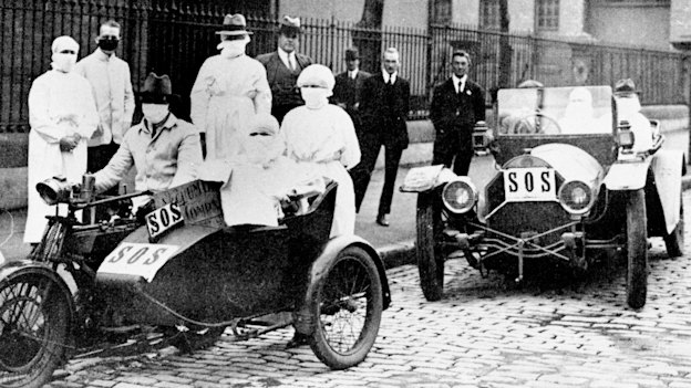 Emergency medical teams in makeshift ambulances during the 1918 outbreak.