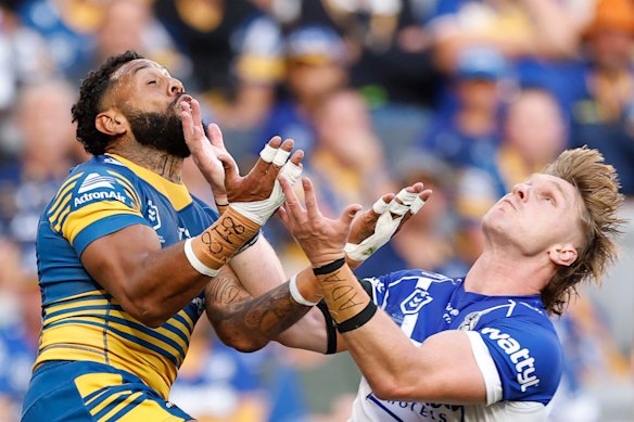 Jacob Preston and Josh Addo-Carr compete for the ball.
