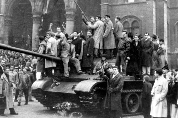 Hungarian rebels wave their national flag from a tank captured in the main square of Budapest, Hungary, in 1956.
