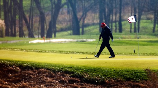 Donald Trump plays golf at his course in Virginia.