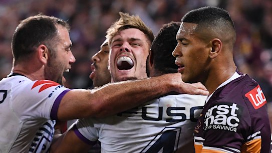 Rampant: Ryan Papenhuyzen (centre) celebrates scoring a try with Storm teammates.