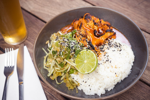 Korean chicken is bathed in a glistening glaze of gochujang-based sauce.