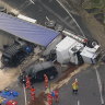Three people were injured and a woman trapped after a truck rolled over on Bells Line of Road in Kurrajong Heights. 