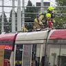 Firefighters atop the roof of the smoking tram at the Chalmers Street stop near Central Station on Thursday morning.