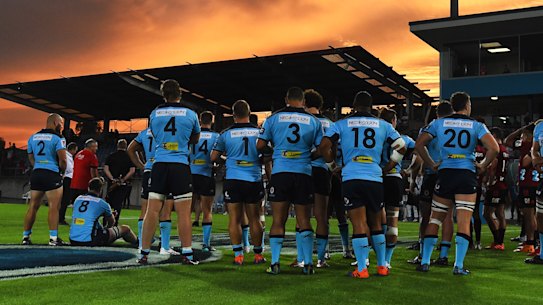 The Waratahs commiserate after their season-opening loss to the Crusaders.