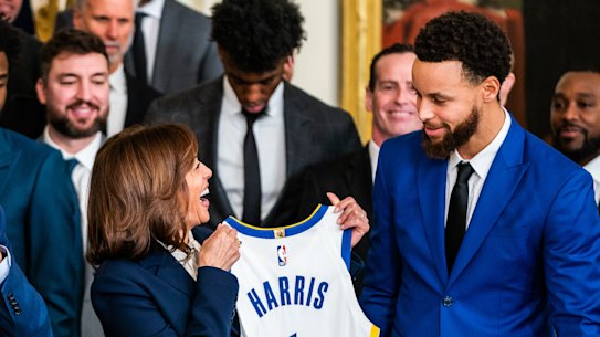 Golden State star Stephen Curry presents Vice President Kamala Harris and President Joe Biden with Warriors jerseys at the White House last year.