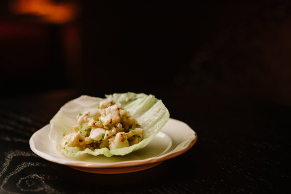 Painted tropical crayfish san choy bao with water chestnuts and coriander. 