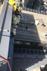 Firefighters on the side of the Melbourne high rise. 