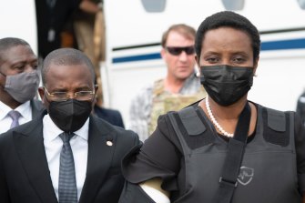 Haiti’s first lady Martine Moise, wearing a bullet proof vest and her right arm in a sling, arrives at the Toussaint Louverture International Airport, in Port-au-Prince, Haiti, Saturday, July 17, 2021. 