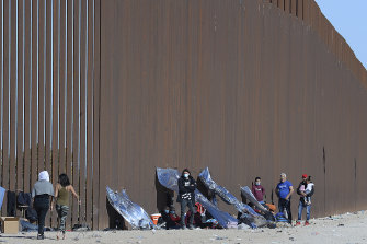 Migrants wait for assistance after crossing into the US in December 2021.