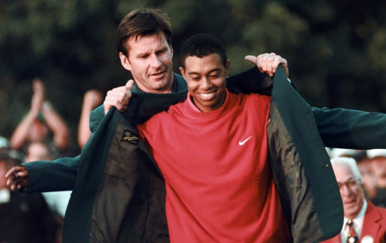 Tiger changed everything: Nick Faldo presents Tiger Woods with his first green jacket in 1997.