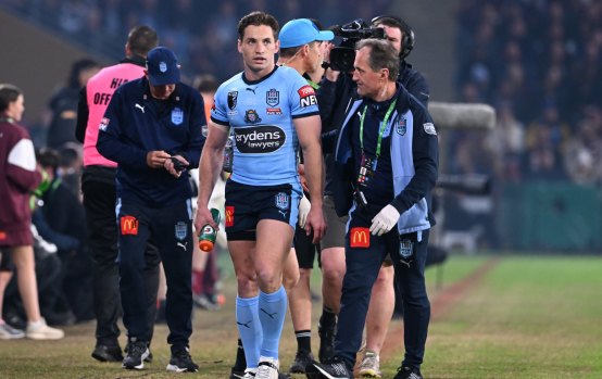 NSW’s Cameron Murray is assisted after sustaining a head injury during the State of Origin decider on Wednesday night.