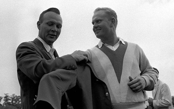 Green machine: Arnold Palmer (left) helps Jack Nicklaus into another green jacket after Nicklaus' nine-stroke victory at the Masters in 1965.