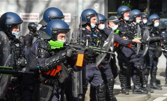 Police fire pepper spray pellets at protesters near Victoria Market on Saturday.