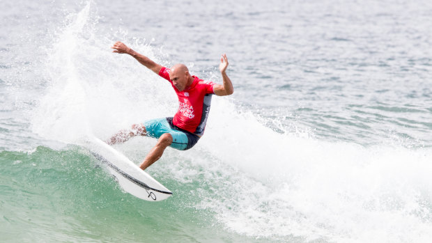 Legend: Kelly Slater carving up the waves at Manly Beach on Wednesday.