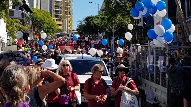 Workers mark Labour Day by marching in Brisbane on Monday.