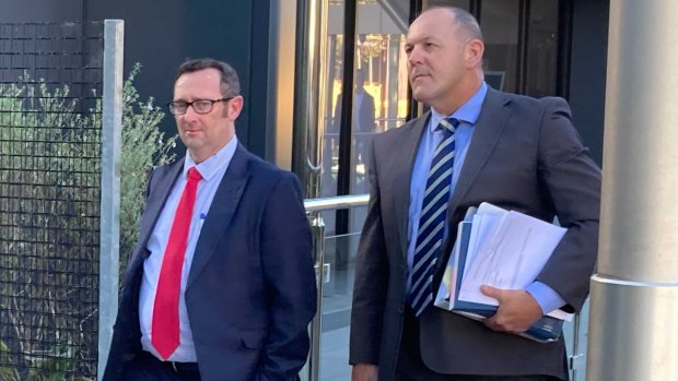 Senior Sergeant Scott Stahlhut (right) leaves Toowoomba Magistrates Court on Wednesday afternoon.